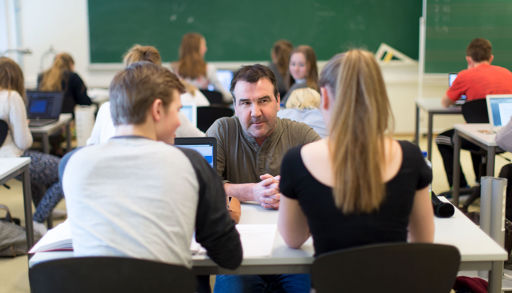 A group of people sitting in a classroom
